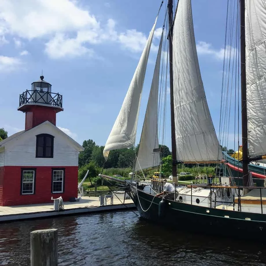 Sailing Saugatuck's schooner docked beside the red lighthouse